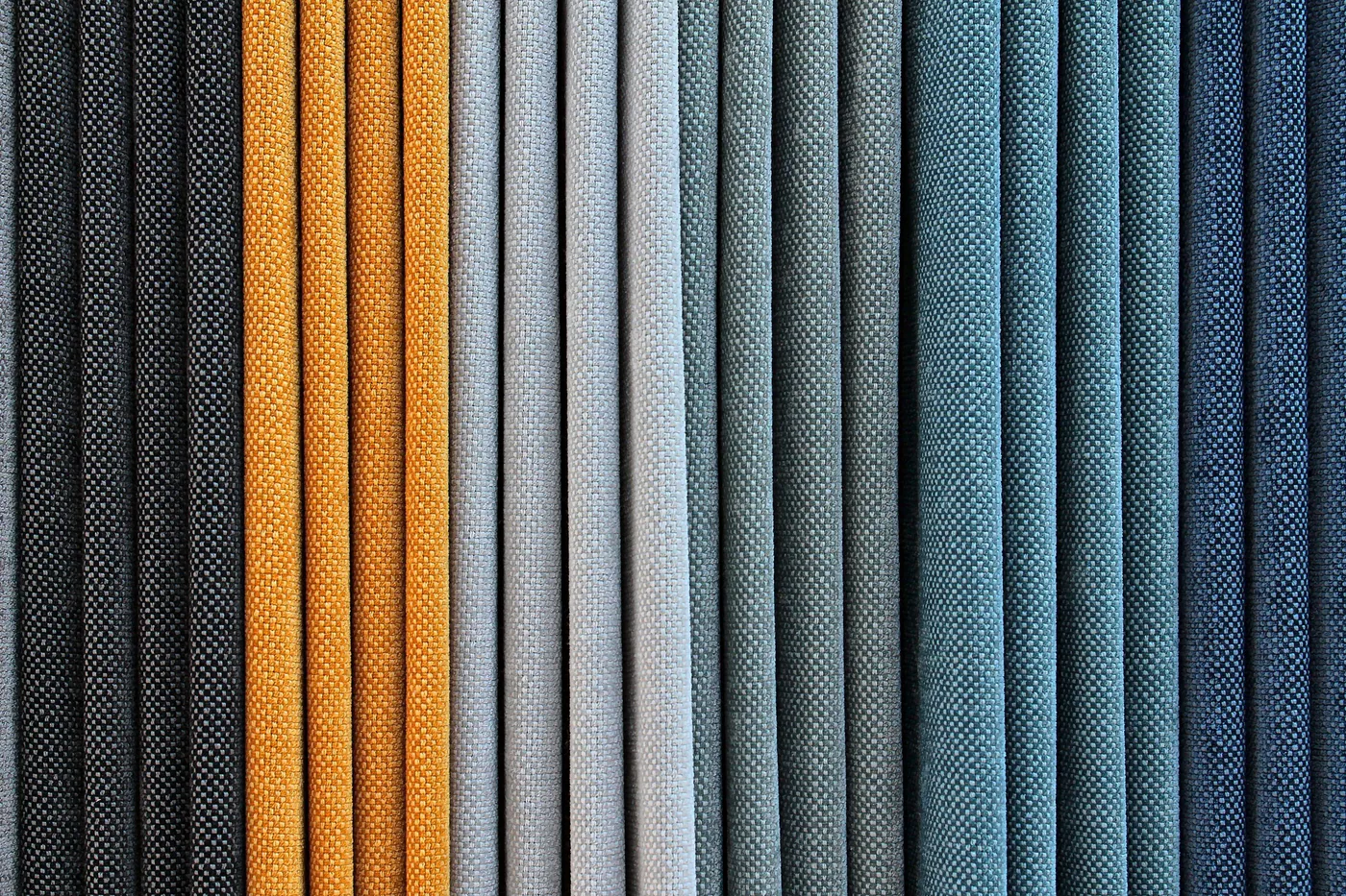 Woven fabric samples in gold, grey and blue